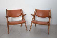 Load image into Gallery viewer, Pair of Sawbuck armchairs CH-28 by Hans J. Wegner for Carl Hansen &amp; Søn